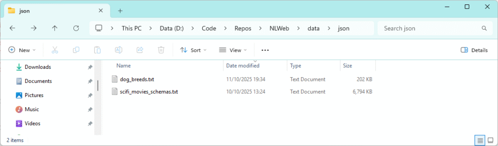 Windows File Explorer showing the json data folder in the NLWeb project containing dog_breeds.txt and scifi_movies_schemas.txt, used for data ingestion in a local AI chat setup with NLWeb, Azure AI Search, and Azure AI Foundry.