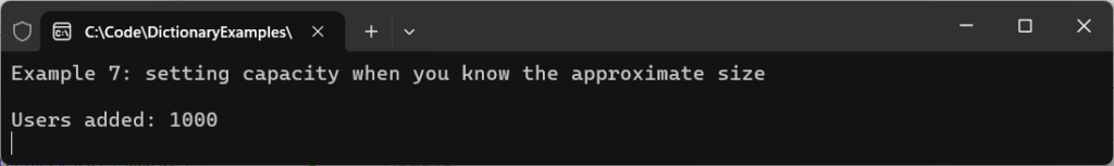 Console output from a C# Dictionary example demonstrating capacity preallocation when adding approximately 1,000 users.